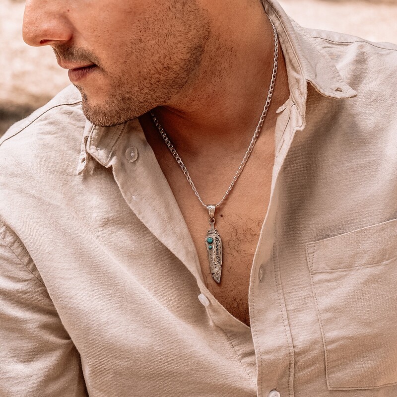 Man wearing a silver with turquoise feather shaped custom pendant necklace